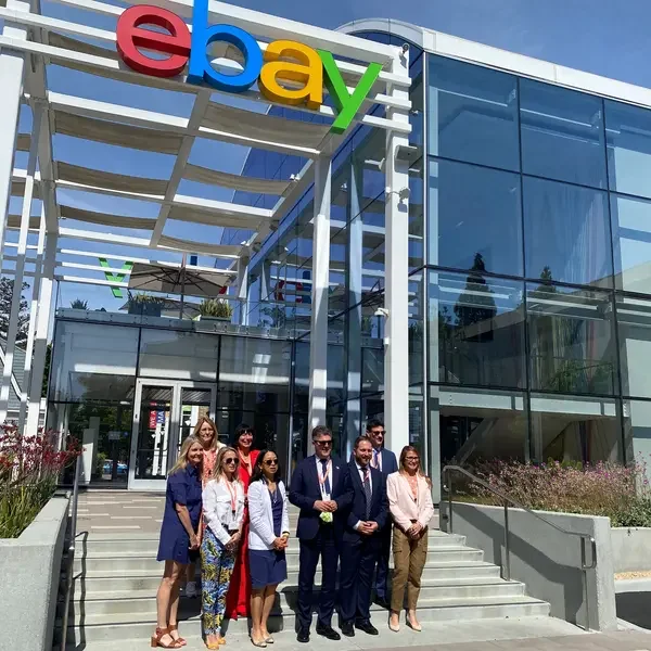 eBay's Marie Huber and Cathy Foster welcome the delegation in front of eBay's Main Street Building