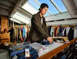A man packing vintage clothes for shipping
