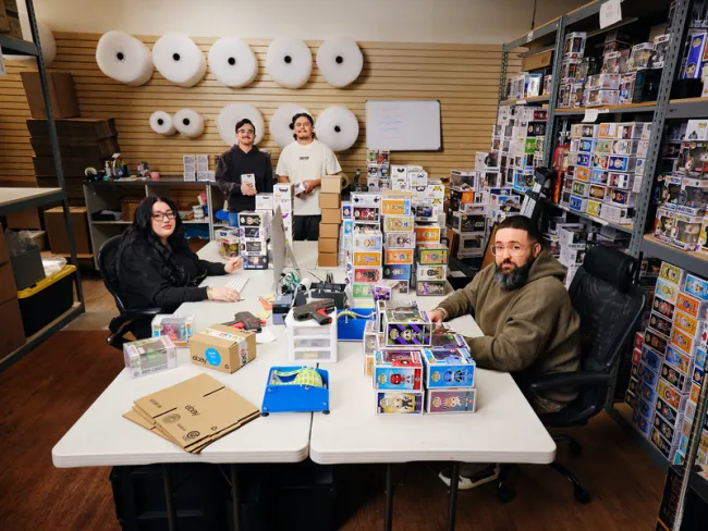 Ebay sellers sitting at a table with their products